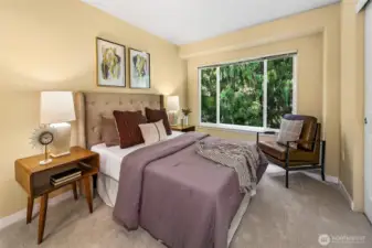 Primary bedroom with wooded views.