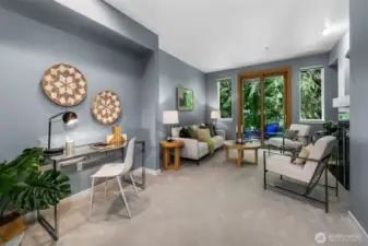 Lovely living room with outlooks of trees; very peaceful.