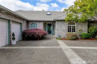Inviting covered entry framed by mature Japanese maple.