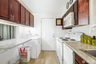 The pass-through on the left makes it easy to set dinner up buffet-style. The door leads to the back yard, patio, storage shed, and carport.
