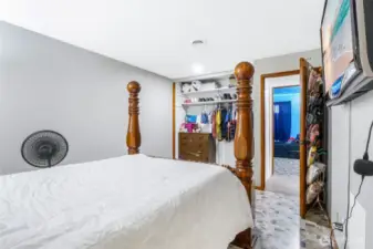 A view of the primary bedroom from the bathroom door. You can see the blue bedroom from here.