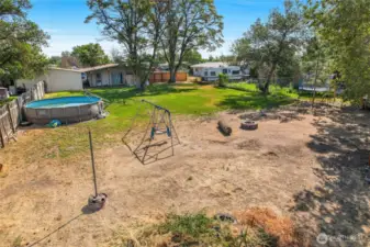 I love this photo! You see the pool, the home, the play area, the tetherball pole, and to the right, out of sight, is the wooden playset and chicken coop.
