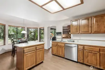 Large kitchen with island and coved dinette area + passthrough window to the family room.