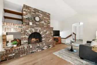 Large wood burning fireplace with brick surround and dedicated wood storage & shelving. Both practical & beautiful!