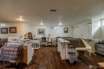 Spacious area for hobbies or home gym? Built in storage along the wall to the right