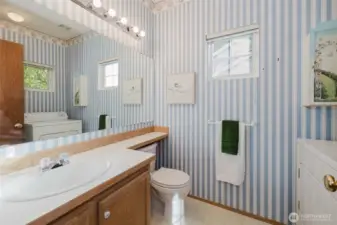 Half bath and laundry room combo on the first floor.