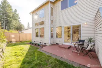 Peaceful backyard with terraced gardens and patio.