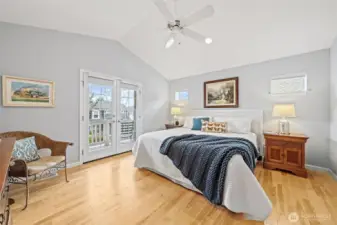 This inviting primary suite features beautiful birch hardwood floors that add warmth and elegance to the space. French doors open to a private balcony, filling the room with natural light and creating a serene retreat to begin and end each day.