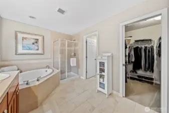 In the Primary Suite bath, ceramic tile flooring enhances the room with a clean, refined look. Just steps away, you’ll find a spacious walk-in closet for effortless organization and a private water closet that adds comfort and convenience.