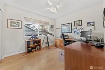 Bedroom Two offers a bright and versatile space, perfect for a home office, guest room, or creative retreat. A large window brings in ample natural light, while the ceiling fan adds year-round comfort.