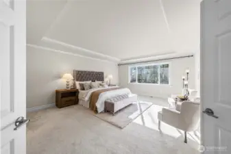 Primary bedroom on upper level has elegant inlay ceiling.