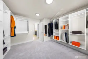 Walk0n closet with built-in shelves.
