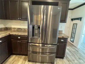 Plenty of countertops and cabinets and this wonderful LG refrigerator provide a great gourmet kitchen experience..