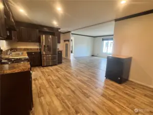 A wonderful open concept home, the kitchen flows into the living room. Notice the luxury vinyl plank flooring that's featured throughout the home.