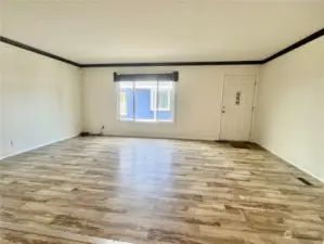 The living room features cove moldings, and an open floor plan.