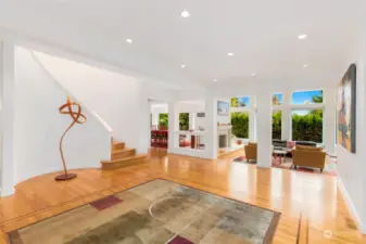 The view from the front entry looking toward staircase to upstairs, living room, and dining room.