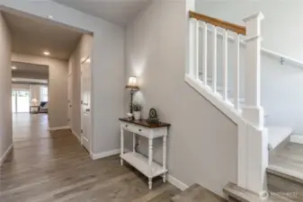 Elegant front entry with custom stairs. Oversized storage closets here, too!