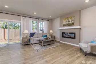 Large living room features a sleek, modern fireplace