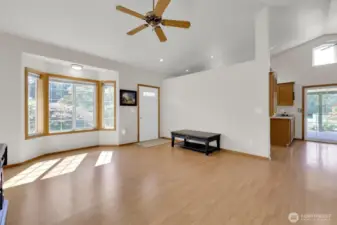 Living area leads to kitchen and back deck.