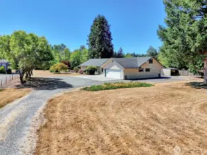 Driving past the front half of the property down the driveway to where the home is located.
