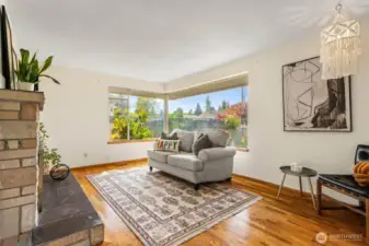 Light-filled living room with huge windows and warm hardwood floors.