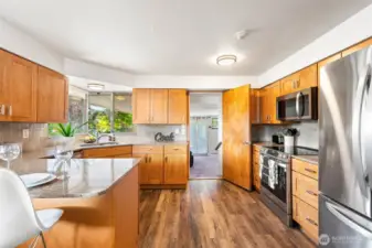 The fully updated kitchen features gleaming granite countertops and brand-new stainless-steel appliances.