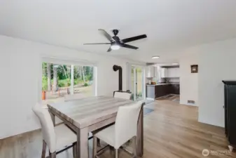 Dining area with laminate floors and ceiling fan.