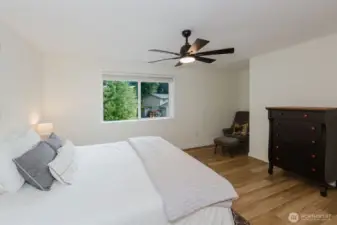 Spacious primary suite with neutral palette and natural light.