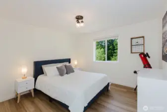 Secondary bedroom with laminate flooring.
