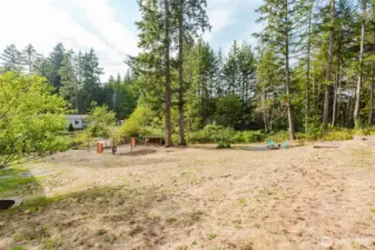 Spacious backyard with mature trees.