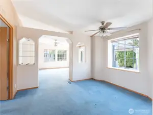 Dining Room with Primary Bedroom on the Left and Family Room Through the Arched Doorway.