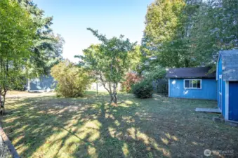 Perspective from the corner of the fully fenced yard looking toward the home.