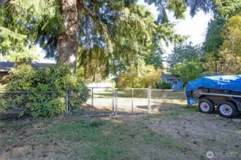 Convenient gate provides access to the fully fenced yard—plenty of room for RVs, toys, or outdoor equipment.