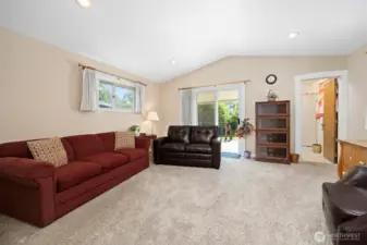 Looking across the family room toward the glass sliding door that opens onto the rear deck.