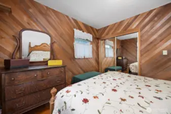 Another view of the primary bedroom with the large closet that has mirrored sliding doors.