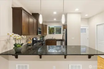 Kitchen with slab granite counters