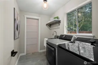 Laundry room with updated washer and dryer that stay