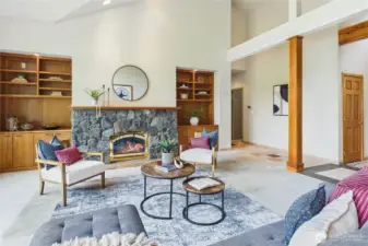 A view of the hand-set, river rock fireplace surround and the custom cherry cabinets and built-ins.