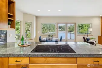 The kitchen and adjacent dining/family room captures the views while also providing access to the wrap-around deck.