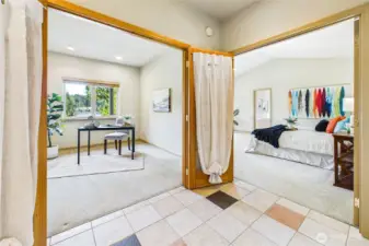 Down the hall from the living room is the den/office space with water views as well as the entry to the primary suite.