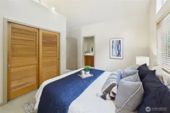 Another view of the second main-floor bedroom with the private, en-suite bath beyond.