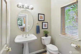 The main floor also features a half bath or powder room tucked away near the garage.