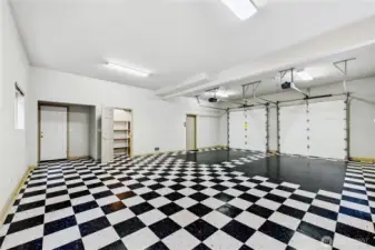 Beautifully finished extended garage space with pantry/storage and man door to the exterior.