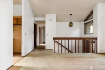 Looking down the hallway with the kitchen on the left and bedrooms at the other end.