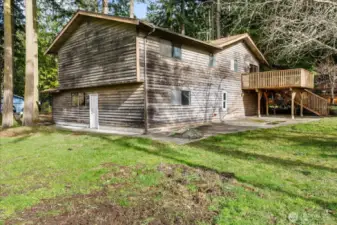 Love the big back yard, patio and deck! A little stain and this siding will look like new!