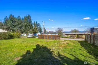 Ground view showcasing flat, buildable lot in Southwest Seattle neighborhood