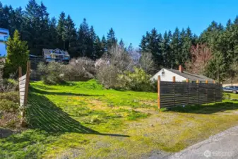 Front-facing view of property with street access and utilities nearby