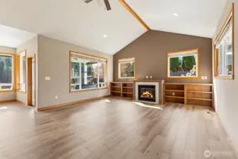 The sunshine pours into this space from every window  look at that reflection off the floor & brand new flooring