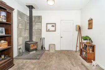 Living room space with a cozy wood burning stove.