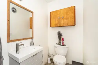 Main bathroom with sink and commode in around the corner.